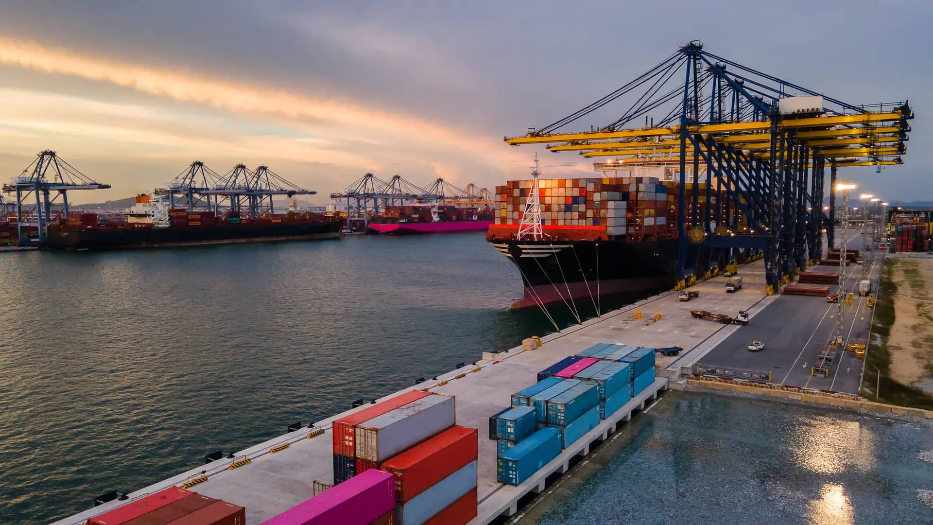 A shipping container port filled with containers and a ship