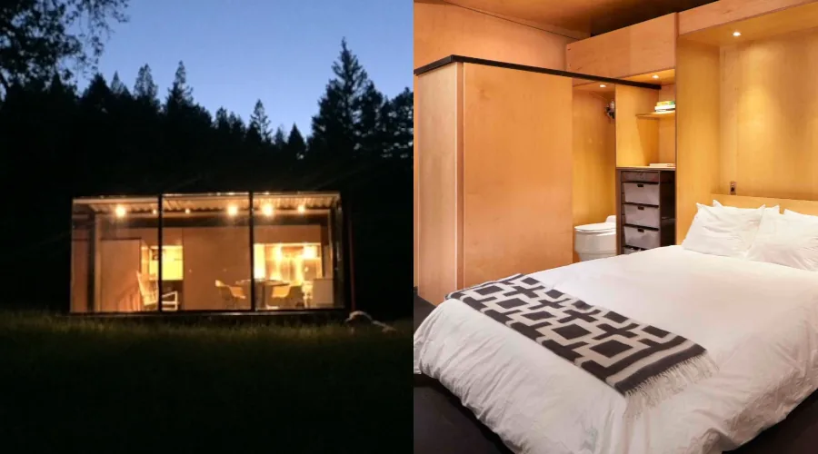 Exterior view of the off-grid expanding container home with its innovative side glass wall folded down, situated in a natural setting and creating a spacious patio area.