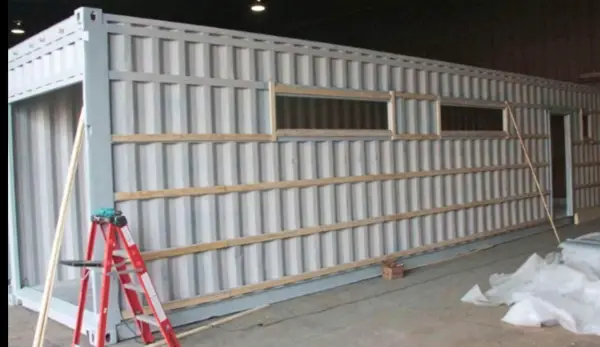 Container with cladding in progress